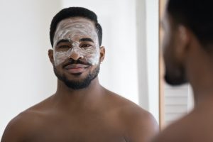 Portrait of African man with applied on face cream mask