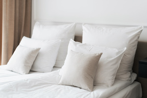 Fresh white linens in comfortable hotel room